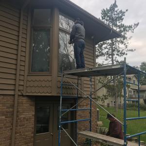 One of our team members handling a two-story window replacement project. 